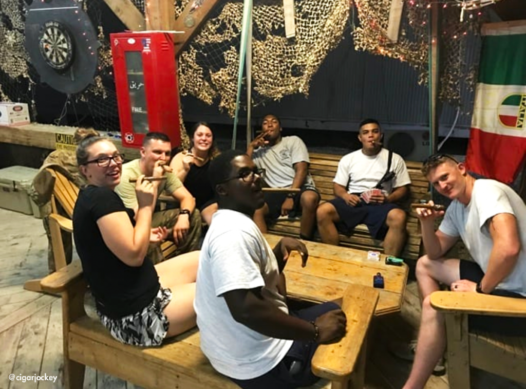 Troops playing cards and enjoying cigars and good conversations.