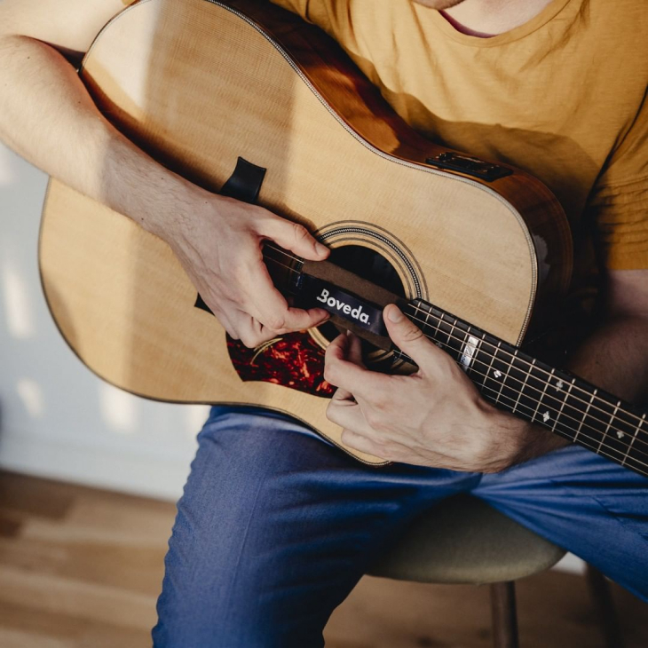 Man holding guitar with Boveda